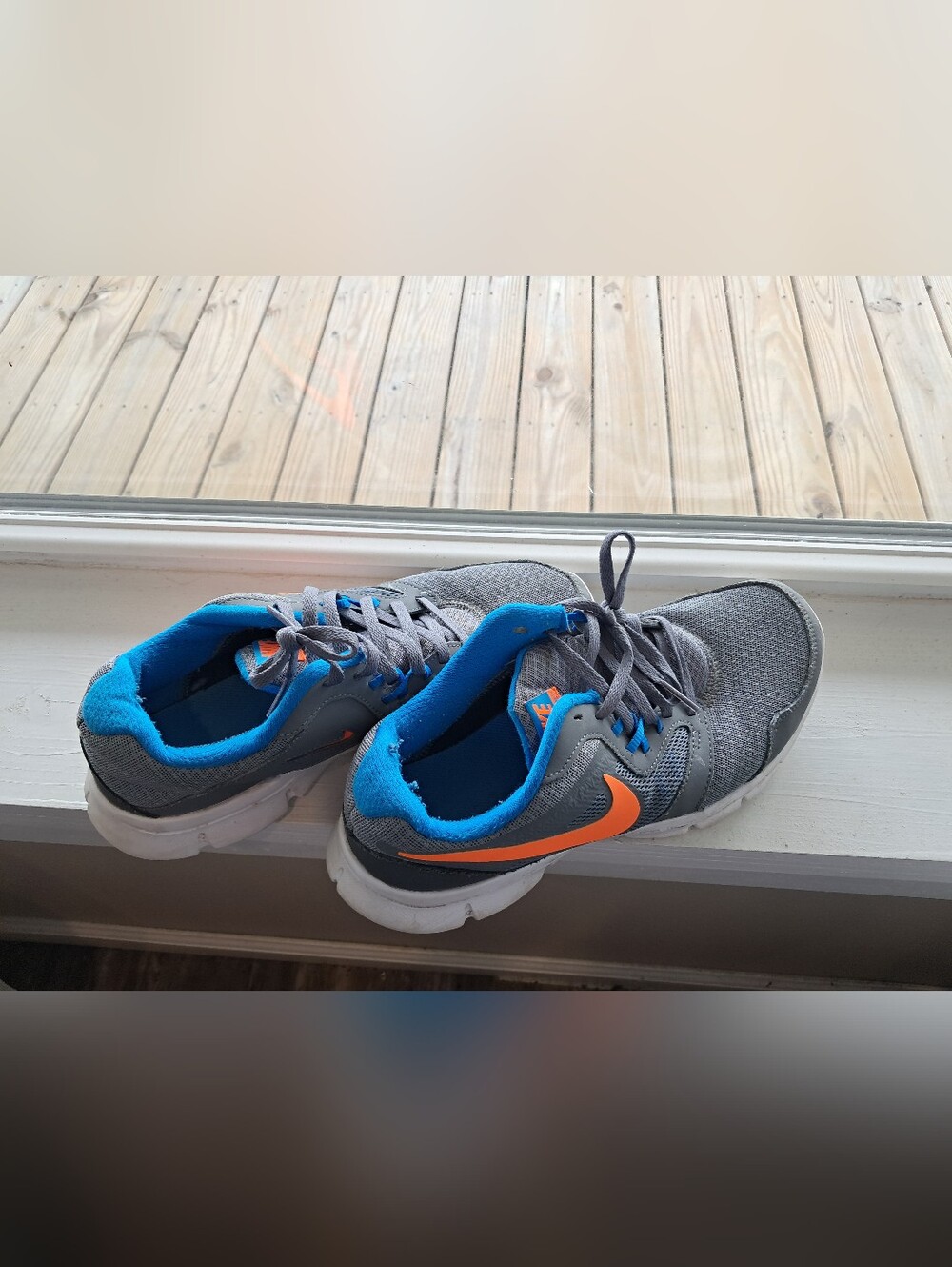 Nike Gray Sneakers with Orange Swoosh and Bright Blue Lining
